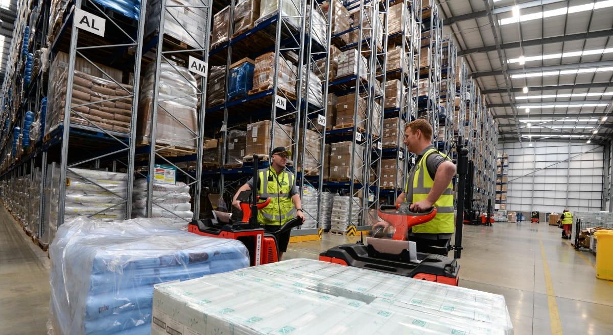 Two workers in fagan & whalley warehouse