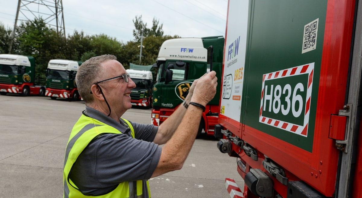 Driver scanning a qr code on a vehicle